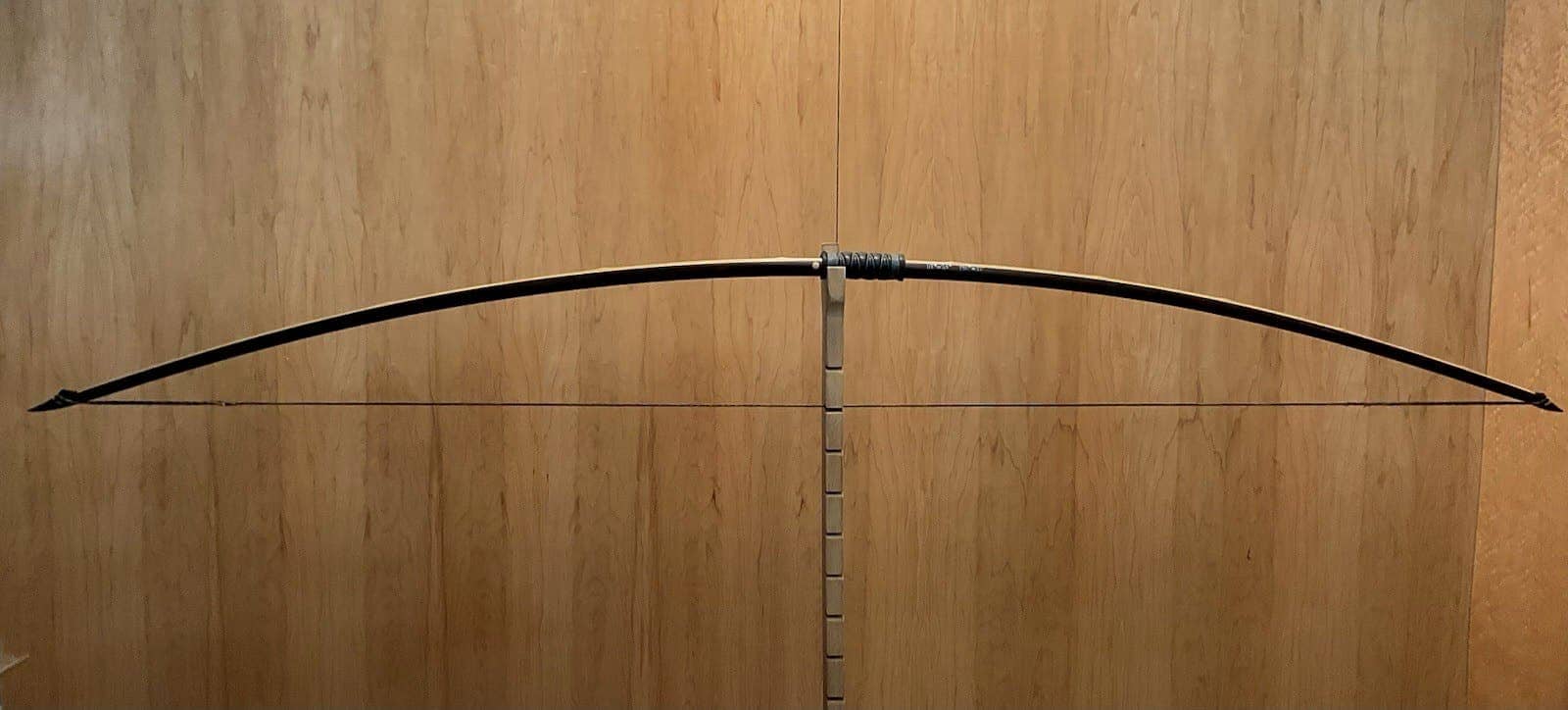 The 115-pound bamboo-backed ipe warbow, braced on Doug's tiller against the maple wall