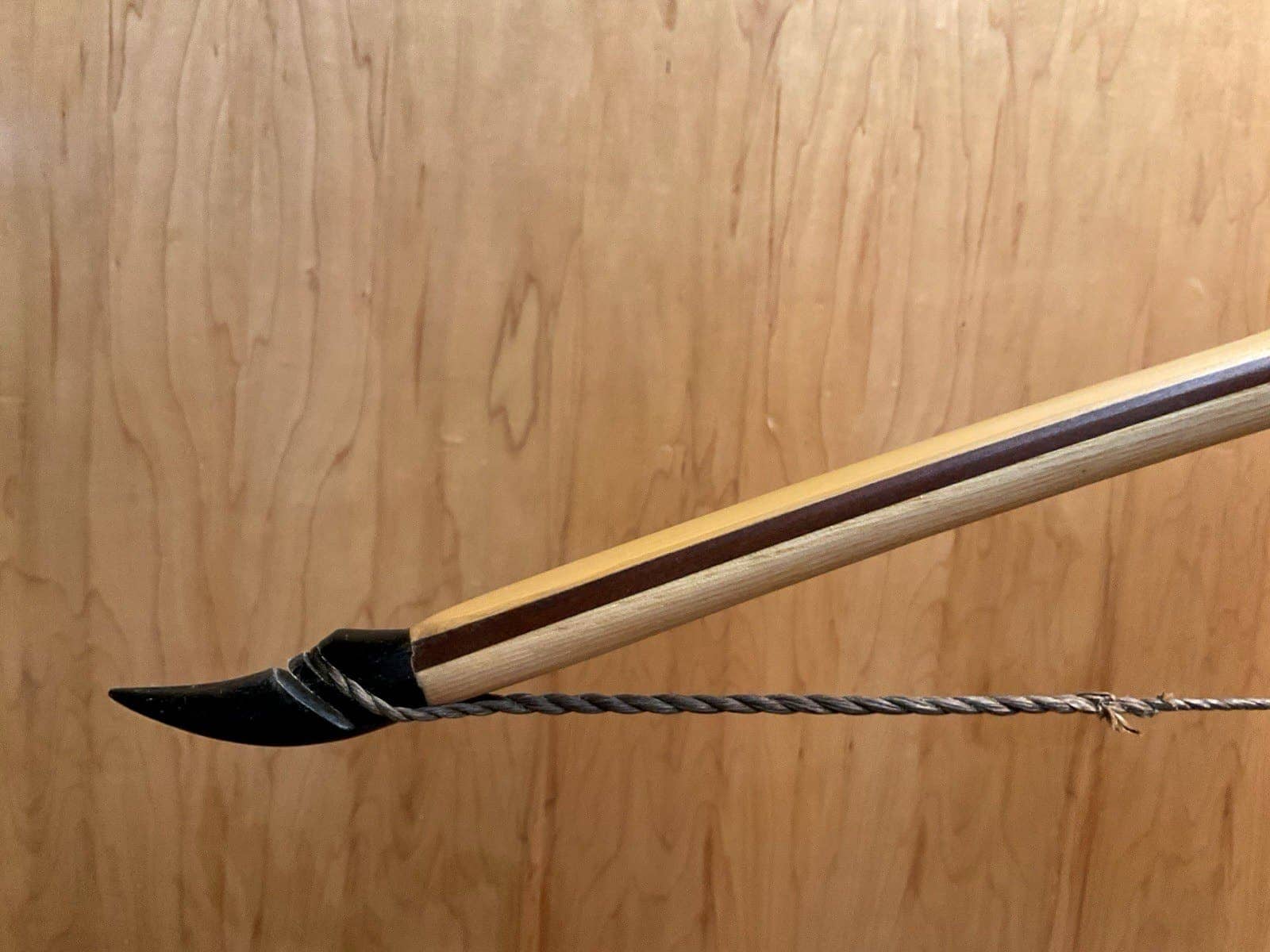 The left buffalo horn tip of the 180-pound bamboo-backed tri-lam warbow, showing its bamboo, ipe and hickory layers