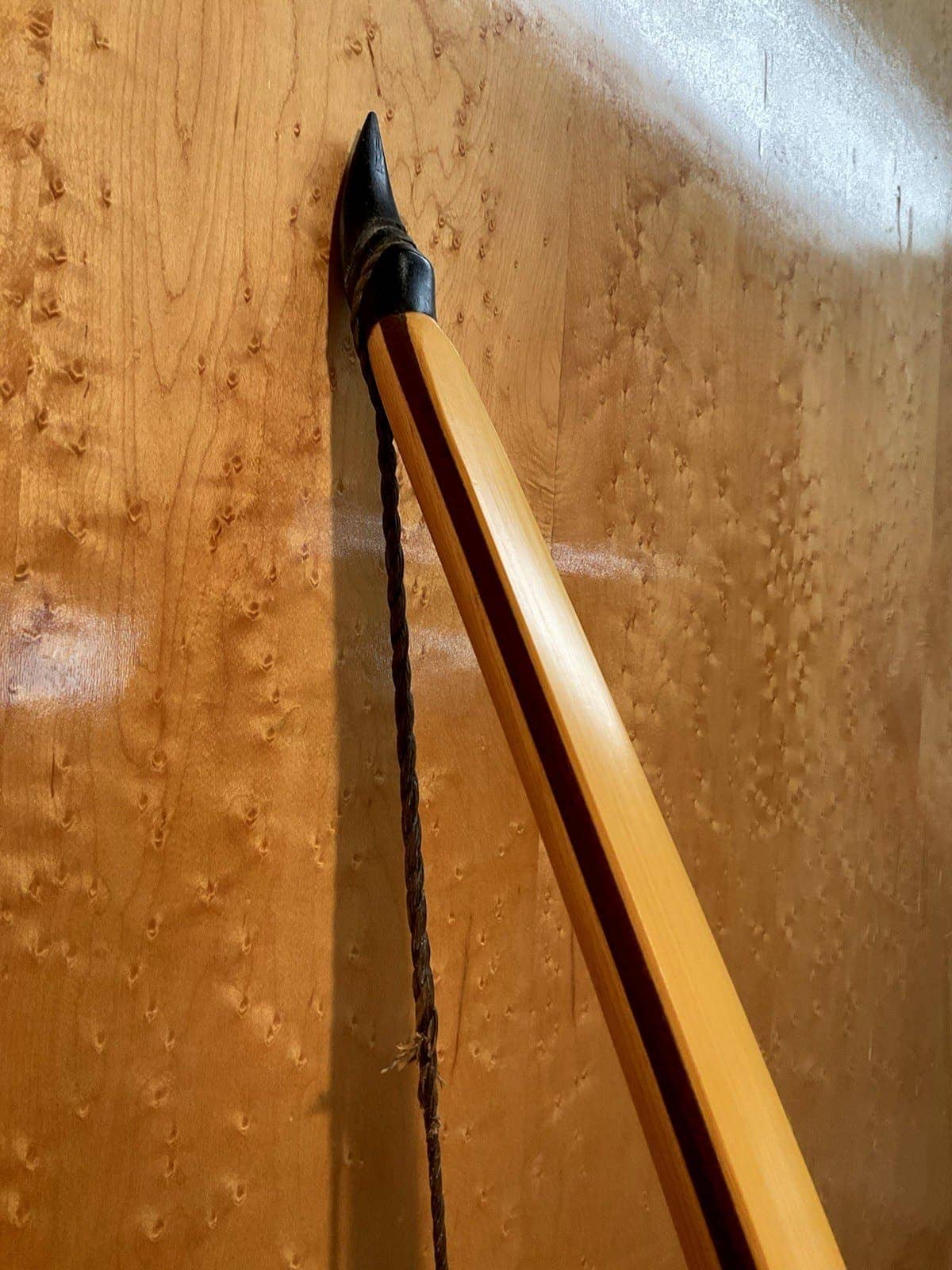 Close-up of the upper horn tip of the 180-pound bamboo-backed tri-lam warbow, the dark ipe core line running up the limb